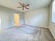 Spacious bedroom with ceiling fan and plush carpeting at 849 Rivers Crossing St, Clermont, FL 34714
