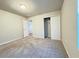 Spacious bedroom with neutral walls, carpet flooring, and an adjacent bathroom at 849 Rivers Crossing St, Clermont, FL 34714