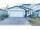 Two-story house with a two-car garage and a brick paver driveway at 849 Rivers Crossing St, Clermont, FL 34714