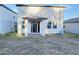 Rear view of the house showing the patio and backyard at 849 Rivers Crossing St, Clermont, FL 34714