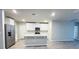 Modern kitchen with white cabinets, quartz countertops, and stainless steel appliances at 849 Rivers Crossing St, Clermont, FL 34714