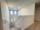 View from upstairs looking down a carpeted staircase to the foyer at 849 Rivers Crossing St, Clermont, FL 34714