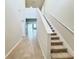 Bright entryway with tile flooring and carpeted staircase at 849 Rivers Crossing St, Clermont, FL 34714