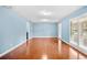 Light blue living room with hardwood floors and white shutters at 8857 Butternut Blvd, Orlando, FL 32817