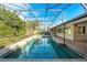 Large screened-in pool with spacious patio at 8857 Butternut Blvd, Orlando, FL 32817