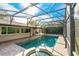 Enclosed pool and spa with a large patio at 8857 Butternut Blvd, Orlando, FL 32817