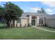 Charming home with a manicured lawn, elegant arched entryway, and tasteful landscaping at 11618 Grand Bay Blvd, Clermont, FL 34711