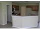 Well-lit kitchen featuring stainless steel appliances, wood cabinets, and breakfast bar at 11618 Grand Bay Blvd, Clermont, FL 34711