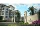 Welcoming gated entrance to Four Seasons Private Residences, framed by manicured greenery and elegant stone pillars at 10601 Autumn Mist Ln # 302, Golden Oak, FL 32836