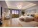Inviting main bedroom features a large window with scenic views and a stylish chandelier at 10601 Autumn Mist Ln # 302, Golden Oak, FL 32836