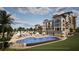 Expansive pool area with rows of lounge chairs and umbrellas, offering a luxurious outdoor experience at 10601 Autumn Mist Ln # 302, Golden Oak, FL 32836
