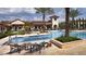 Inviting pool area with lounge chairs, palm trees, and a resort-style atmosphere at 10601 Autumn Mist Ln # 302, Golden Oak, FL 32836