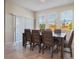 Bright dining room with a large table and six chairs, and sliding glass doors to patio at 1016 Downswing Pl, Davenport, FL 33896
