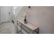 Bright entryway with tiled floor, glass-top console table, and staircase at 1016 Downswing Pl, Davenport, FL 33896