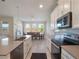 Modern kitchen with white cabinets, gray countertops, and stainless steel appliances at 1016 Downswing Pl, Davenport, FL 33896