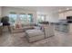 Spacious living room with sectional sofa, large windows, and an open floor plan at 1016 Downswing Pl, Davenport, FL 33896