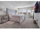Spacious main bedroom with plush bed, large windows, and mirrored dresser at 1016 Downswing Pl, Davenport, FL 33896