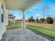 Spacious covered patio with pavers overlooking the backyard at 1016 Downswing Pl, Davenport, FL 33896