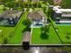Overhead view of a stunning home with a large pool and boat dock on a lush, green property at 10416 Pocket Ln, Orlando, FL 32836