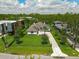 Aerial view of a beautifully landscaped home with a long driveway and fenced yard at 10416 Pocket Ln, Orlando, FL 32836