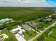 Expansive aerial view showcasing luxury homes with lush green landscape and natural water features under a cloudy sky at 10416 Pocket Ln, Orlando, FL 32836