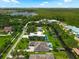 Aerial view featuring a luxury home with pool and lush landscaping, situated near a lake and green forest at 10416 Pocket Ln, Orlando, FL 32836