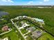 Wide aerial view displaying luxury homes with lush greenery, bordering a dense forest and a distant lake at 10416 Pocket Ln, Orlando, FL 32836