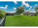 Spacious backyard with lush lawn, modern pool, and waterfront access, perfect for outdoor living and entertaining at 10416 Pocket Ln, Orlando, FL 32836