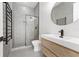 Modern bathroom with a glass-enclosed shower and sleek vanity with black fixtures at 10416 Pocket Ln, Orlando, FL 32836