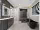 Modern bathroom featuring a large vanity with double sinks, a soaking tub, and a glass enclosed shower at 10416 Pocket Ln, Orlando, FL 32836