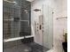 Luxurious shower showcasing dual showerheads, sleek tiling, and a built-in bench for a spa-like experience at 10416 Pocket Ln, Orlando, FL 32836