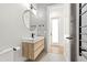 Modern bathroom with floating vanity and black fixtures, door to separate water closet to the rear at 10416 Pocket Ln, Orlando, FL 32836