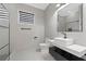 Modern bathroom with floating vanity, black fixtures, and glass shower, designed for relaxation at 10416 Pocket Ln, Orlando, FL 32836