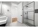 Modern bathroom featuring gray tile, a glass shower and black hardware at 10416 Pocket Ln, Orlando, FL 32836