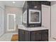 Modern bathroom with double vanity, lighted mirrors, and marble countertops at 10416 Pocket Ln, Orlando, FL 32836