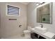 Modern bathroom featuring neutral tile, a sleek vanity with a vessel sink, and a glass-enclosed shower for a clean look at 10416 Pocket Ln, Orlando, FL 32836
