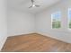 Bright bedroom featuring hardwood floors and plantation shutters for natural light at 10416 Pocket Ln, Orlando, FL 32836