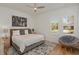 Serene bedroom with a queen-size bed, hardwood floors, plantation shutters, and a cozy papasan chair in the corner at 10416 Pocket Ln, Orlando, FL 32836