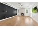 Spacious bedroom featuring a fireplace, a black accent wall, and wood flooring at 10416 Pocket Ln, Orlando, FL 32836