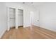 Bedroom with hardwood floors and closet with organized shelving, providing ample storage at 10416 Pocket Ln, Orlando, FL 32836