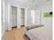Bright bedroom with hardwood floors and closets featuring ample storage space at 10416 Pocket Ln, Orlando, FL 32836