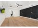 Spacious bedroom featuring wood floors, crown molding, modern ceiling fan, and a black accent wall at 10416 Pocket Ln, Orlando, FL 32836