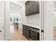 Charming butler's pantry with custom cabinets, wine rack, beverage fridge, and granite countertops at 10416 Pocket Ln, Orlando, FL 32836