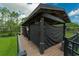 Covered boat dock featuring a wooden deck, black supports, and shielding fabric on a waterway at 10416 Pocket Ln, Orlando, FL 32836
