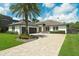 Beautiful single-story home features a brick driveway, manicured lawn, and a modern design at 10416 Pocket Ln, Orlando, FL 32836