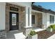 The exterior of a home showcasing the front door with stone accents, columns, and manicured landscaping at 10416 Pocket Ln, Orlando, FL 32836