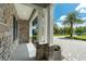 Home featuring a stone facade, covered front porch with stone columns, and manicured landscaping at 10416 Pocket Ln, Orlando, FL 32836