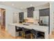 Modern kitchen featuring an island with seating, stone counters, and stainless steel appliances at 10416 Pocket Ln, Orlando, FL 32836