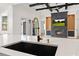 Kitchen detail showcasing the stainless sink, gold faucet, granite countertop, and custom fireplace wall at 10416 Pocket Ln, Orlando, FL 32836