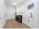 Well-lit laundry room with modern washer and dryer, cabinets and countertop space at 10416 Pocket Ln, Orlando, FL 32836